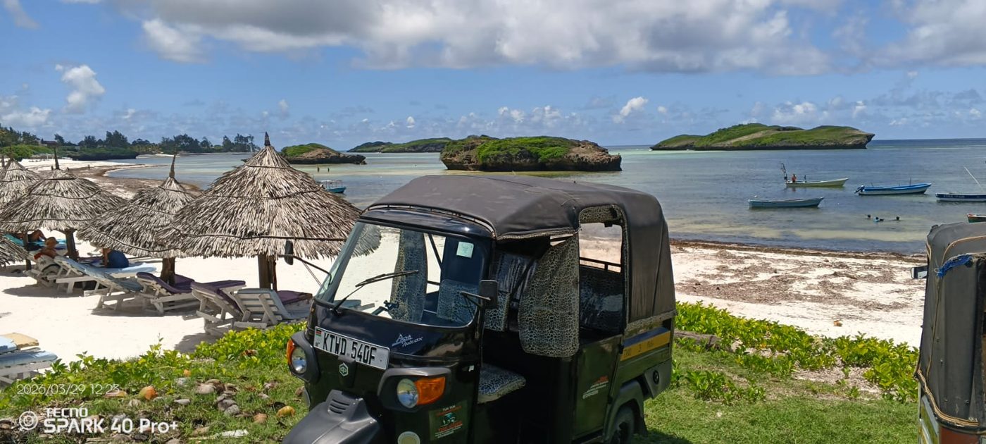 Mose's tuk tuk overlooking the turquoise bay and islands at Watamu beach