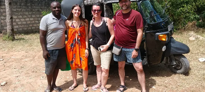 Mose with happy riders in front of his tuk tuk in Watamu, Kenya